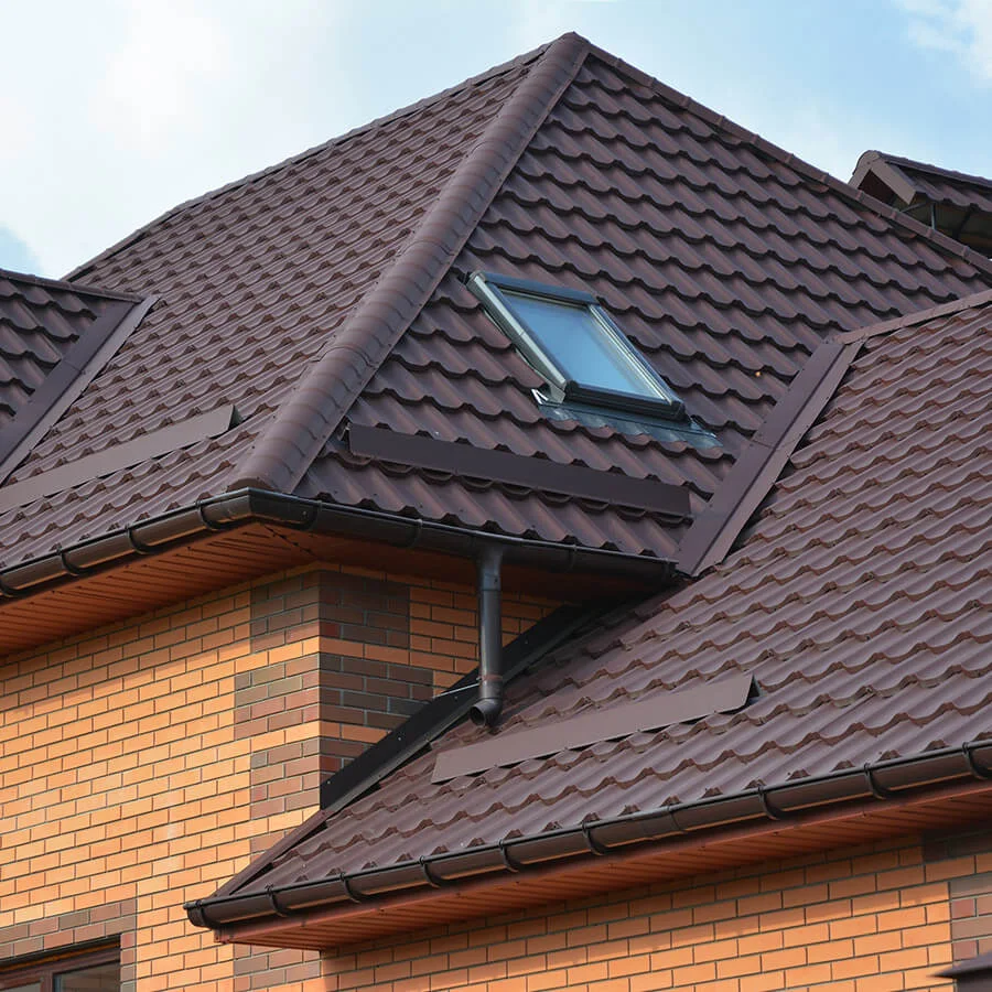 A roof of a house with windows under a clear sky.