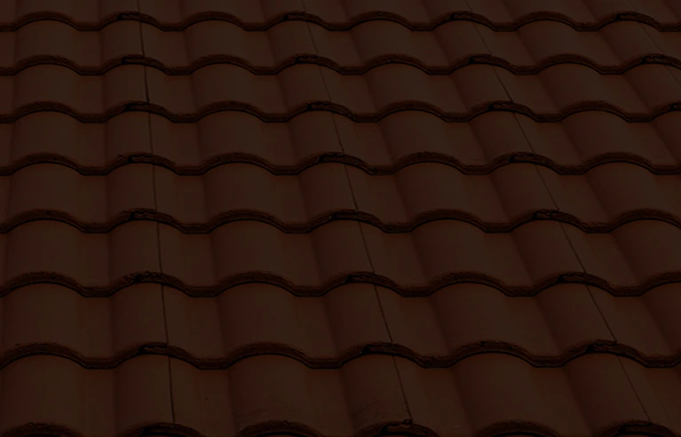 Close-up view of a red clay tile roof with a repeating wave-like pattern, photographed symmetrically from above.